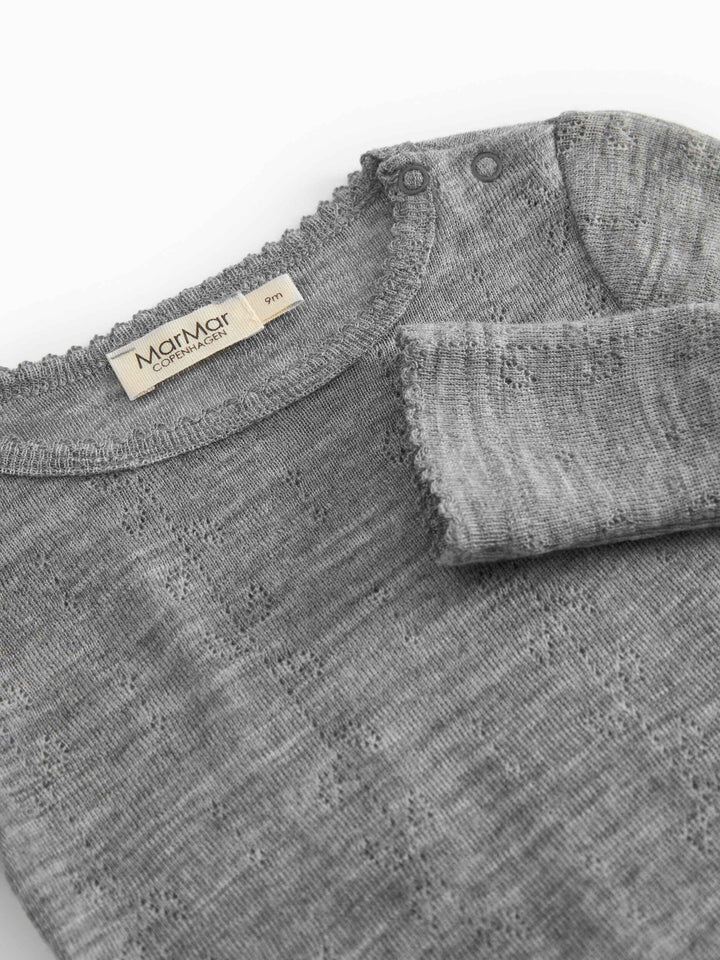 Gray textured fabric with a brand label on a white background