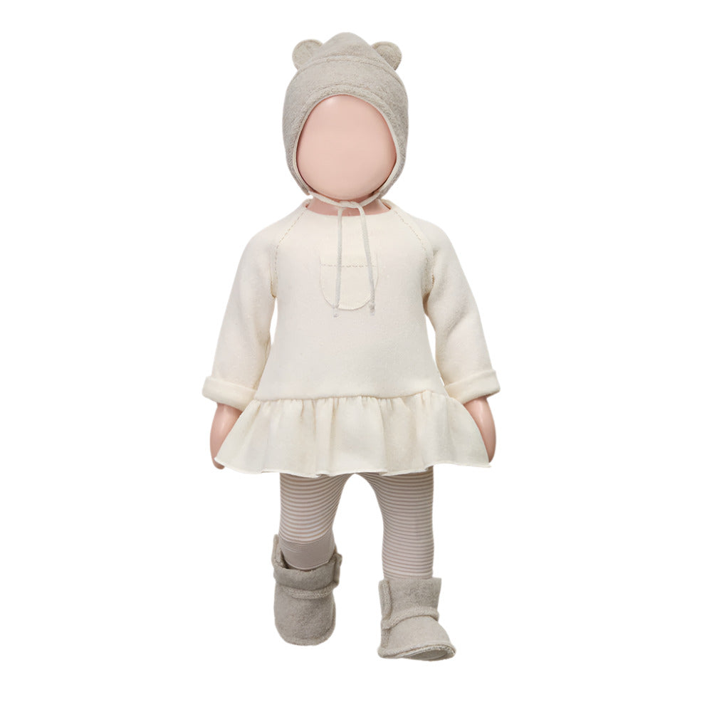 Baby outfit with white dress, beige bonnet, and boots on a white background