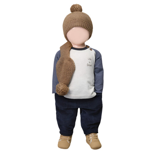 Child's outfit with a knit hat, scarf, and shoes on a white background
