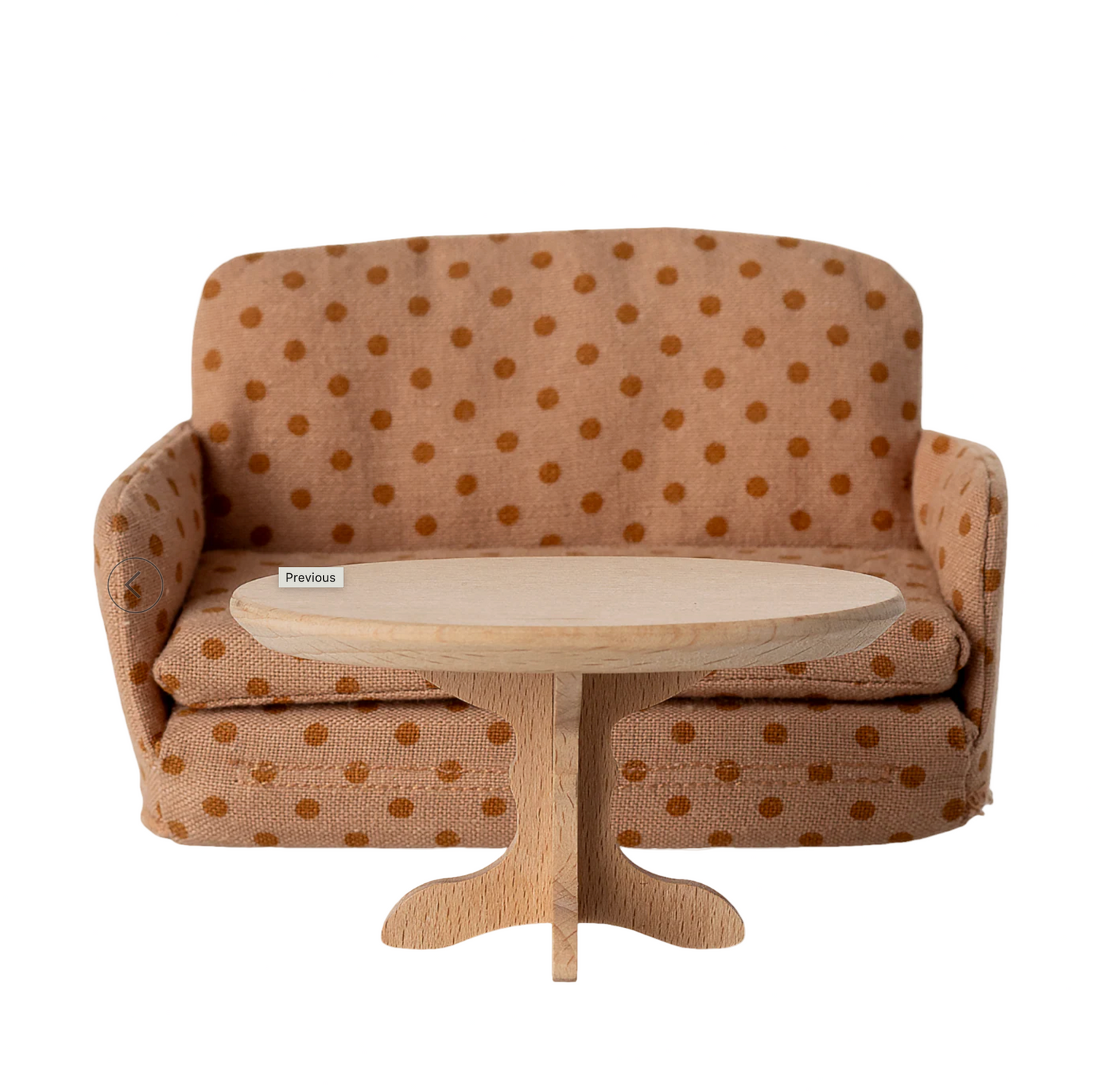 Brown polka dot sofa with a wooden coffee table on a computer screen.