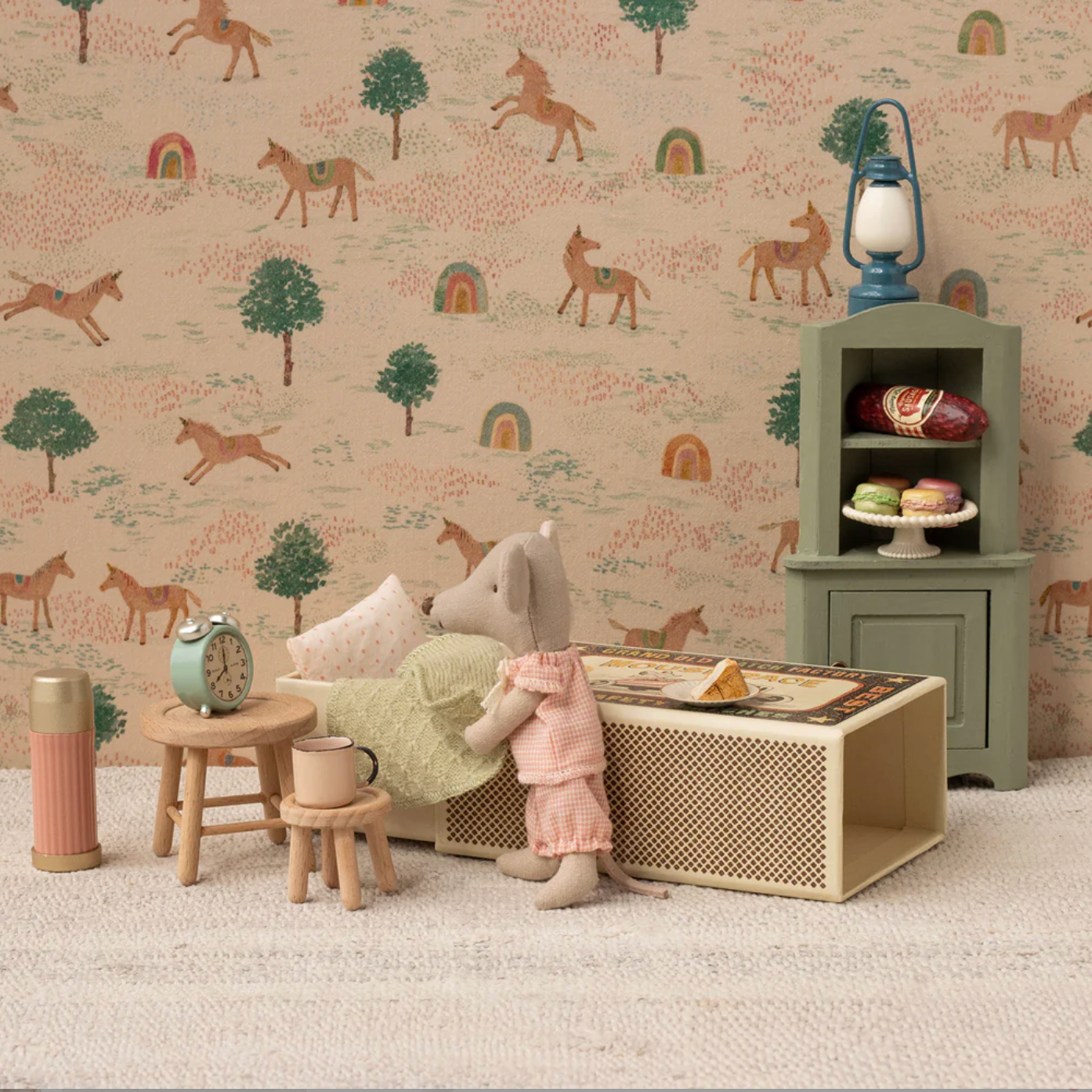 Children's room with toy mouse, furniture, and decorative items against a wallpaper with animal patterns. - Little-ish