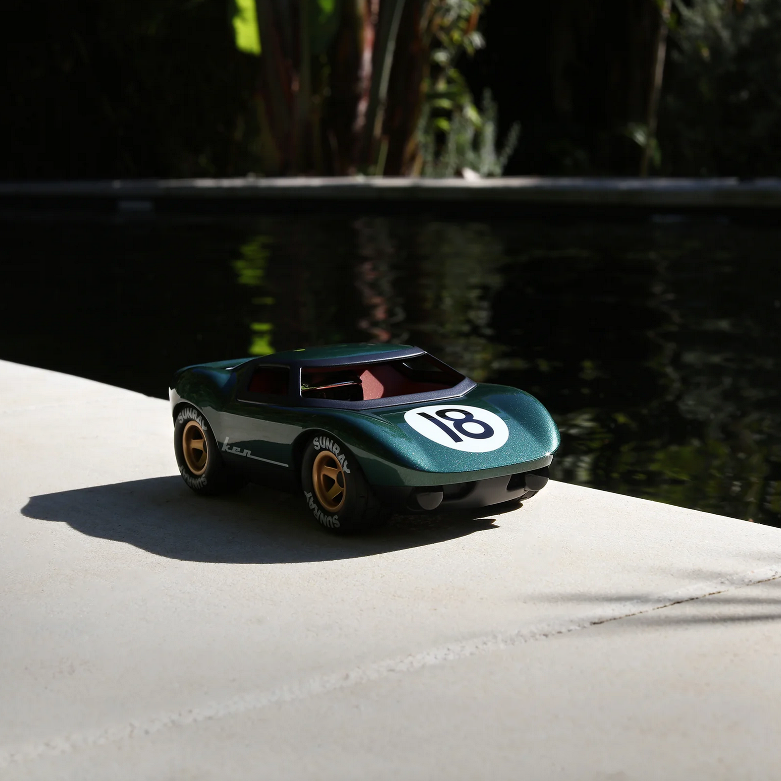 Model car with number 18 on a concrete surface near water - Little-ish