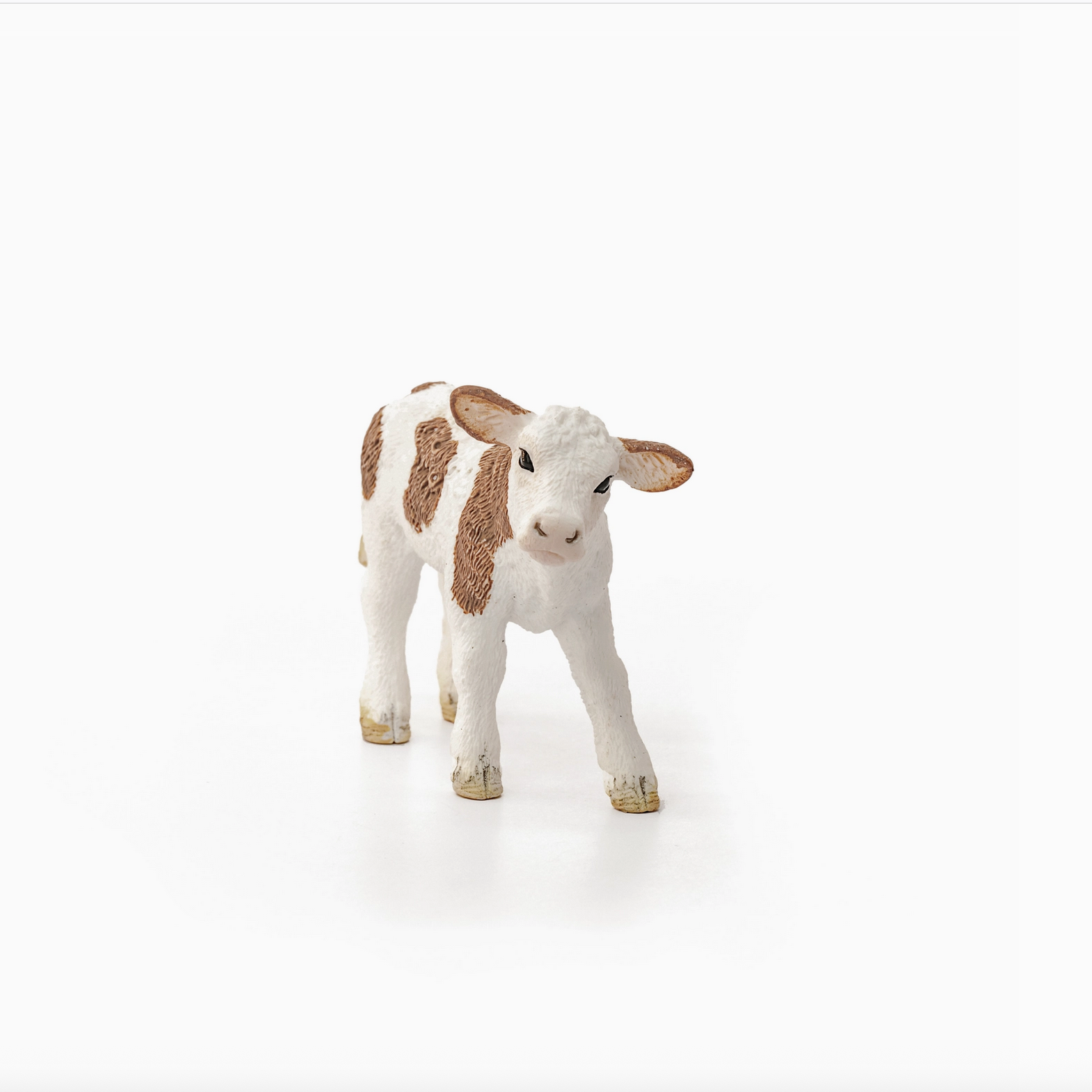 Stuffed animal cow toy on a white background - Little-ish