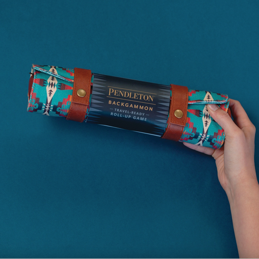 Pendleton backgammon roll-up game set held by a hand against a blue background