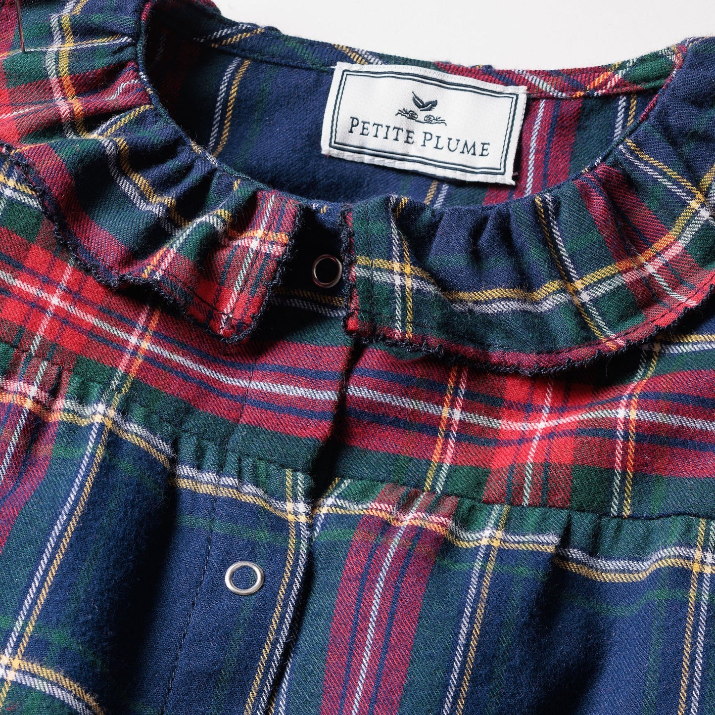 Plaid fabric with a visible brand label on a plain background