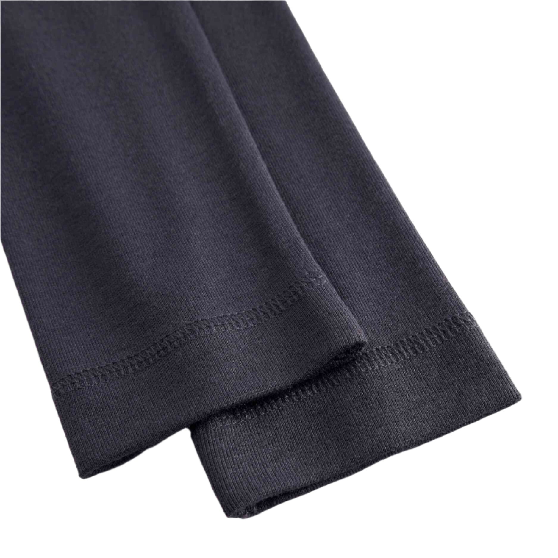 Close-up of dark gray pants on a white background