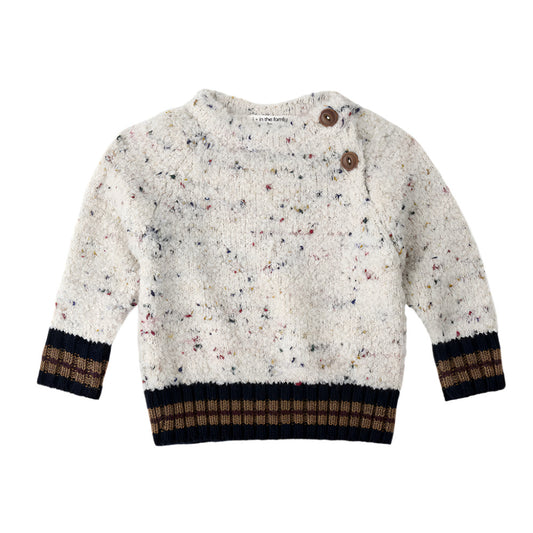 Children's sweater with speckled pattern and brown buttons on a white background