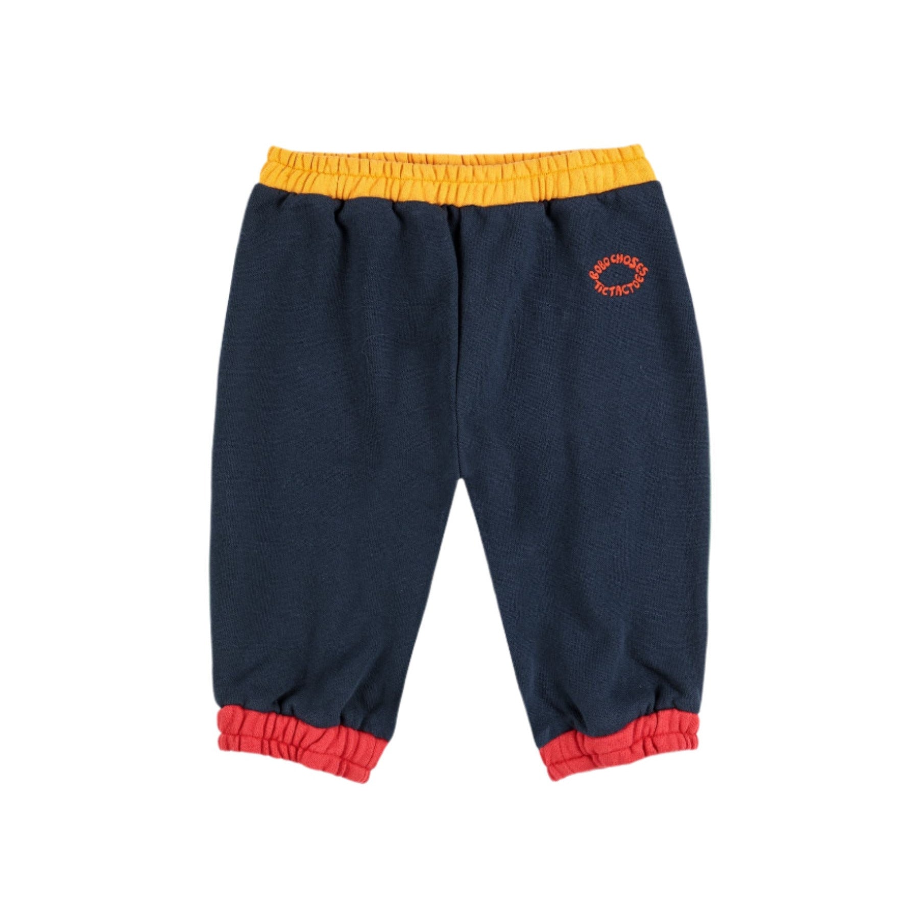 Navy blue sweatpants with yellow waistband and red cuffs on a white background - Little-ish