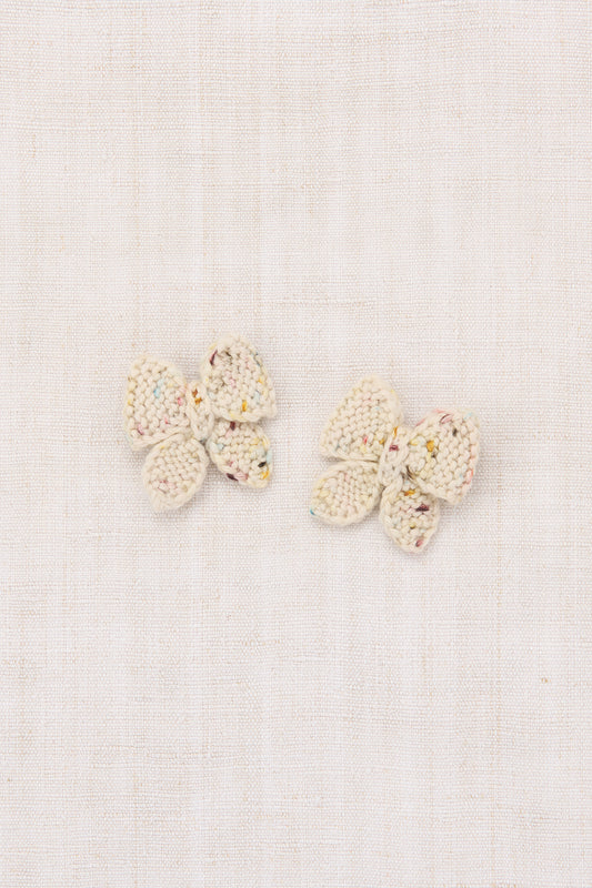 Pair of butterfly-shaped earrings on a light background