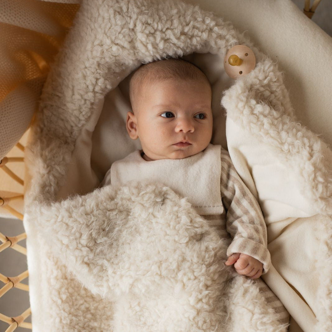 Baby wrapped in a soft, wool textured stroller blanket - Little-ish