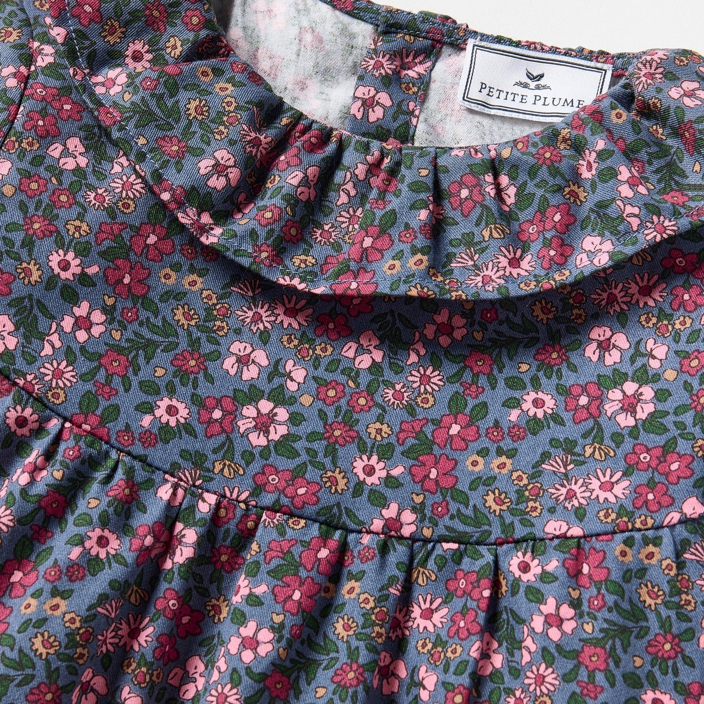 Floral patterned fabric with a brand label on a white background