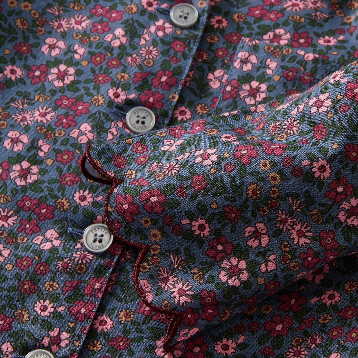 Floral patterned shirt with a close-up of buttons and fabric texture.
