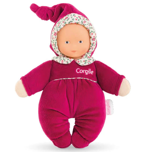 Toy doll in a pink outfit with a floral hood on a white background