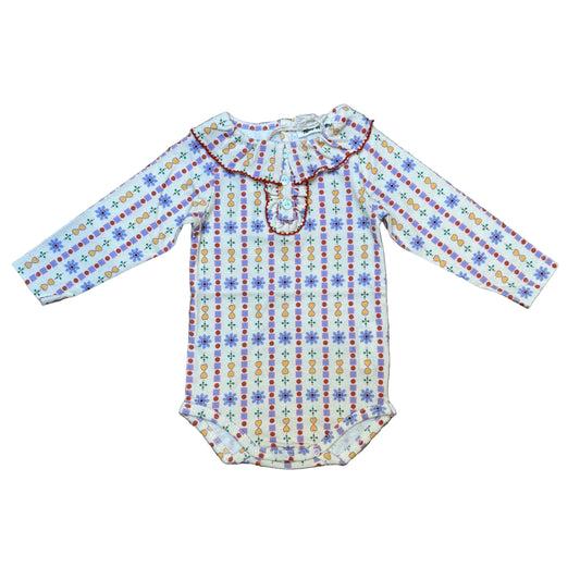 Colorful patterned fabric on a textured surface