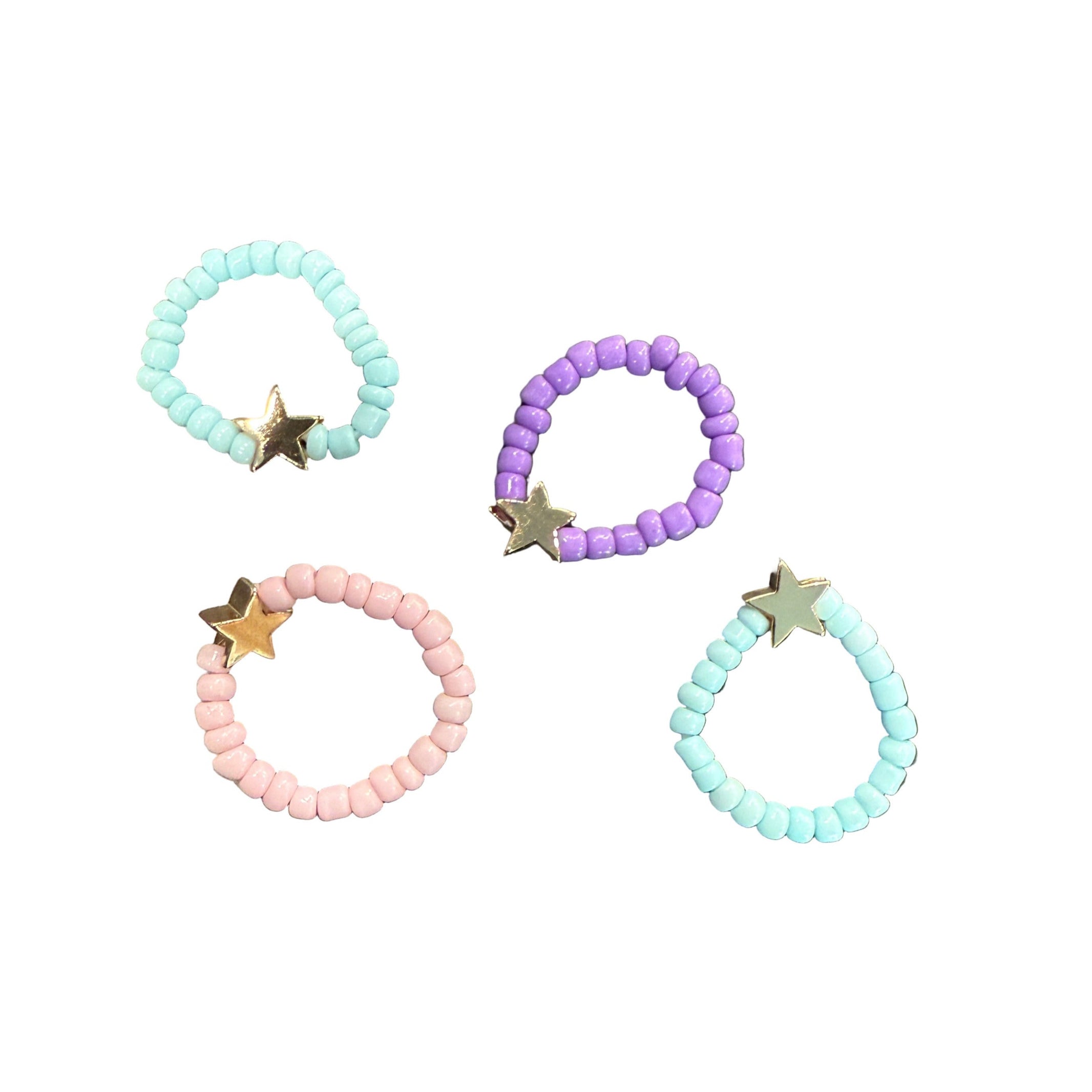 Set of beaded bracelets with star charms on a textured surface - Little-ish