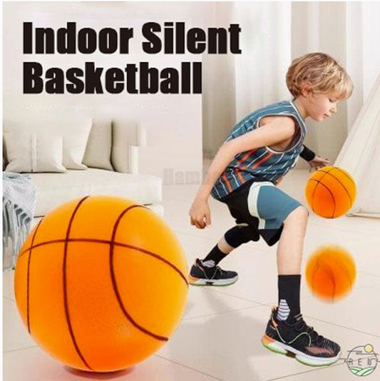 A child is practicing basketball indoors with a silent basketball, which is bouncing silently. The child is wearing a basketball outfit and sneakers, actively engaging with the ball.