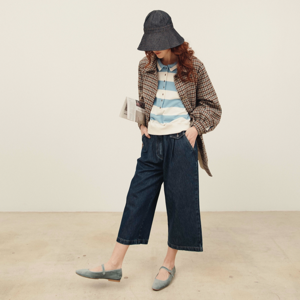 Person wearing a plaid jacket, striped shirt, and wide-leg jeans against a plain background - Little-ish