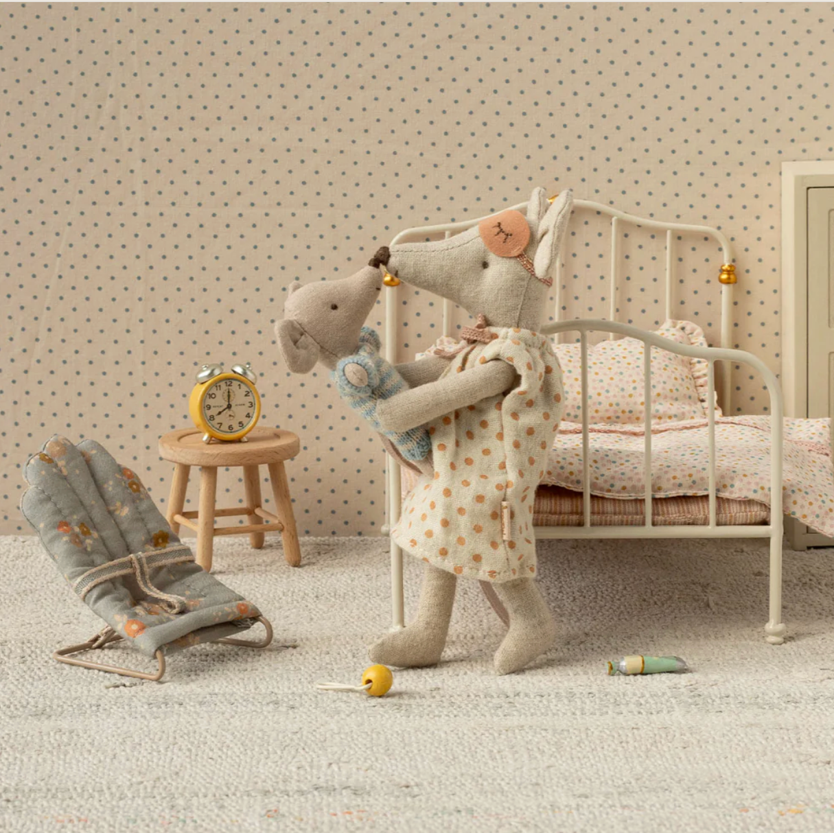 Stuffed elephant toy in a child's bedroom with a bed, chair, and clock. - Little-ish