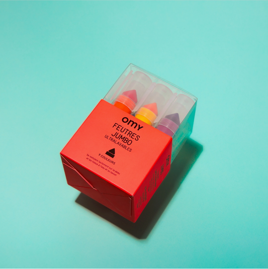 Box of OMY Feutres Jumbo chalks on a light blue background