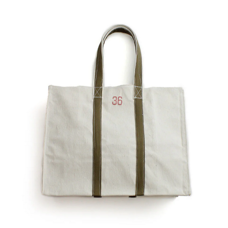 White tote bag with green straps on a white background - Little-ish