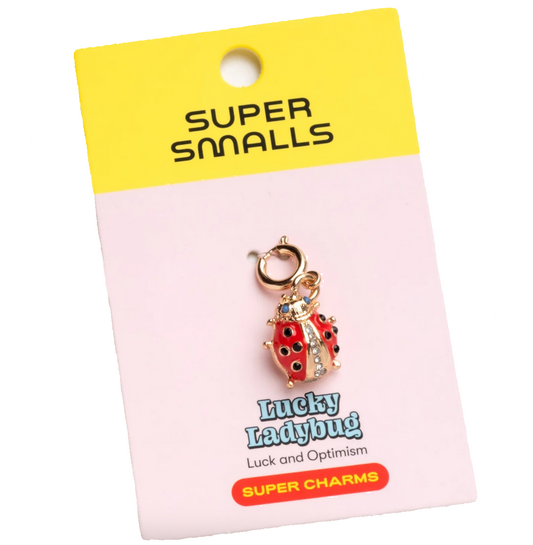 Lucky ladybug charm on a 'Super Smalls' branded card with yellow and pink design.