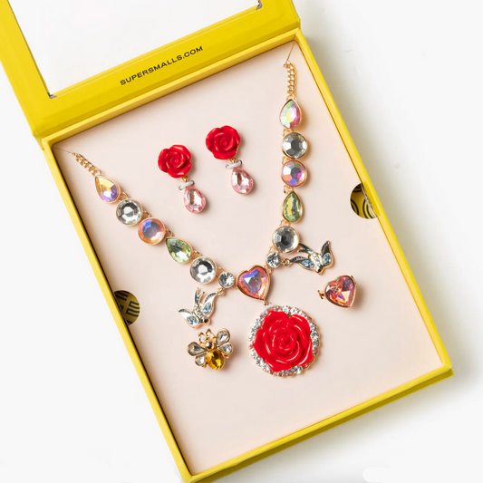 Jewelry set with necklaces and earrings in a yellow box on a white background