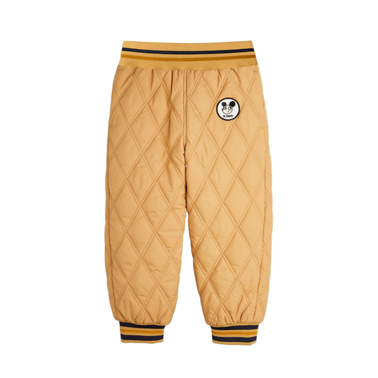 Beige quilted pants with a patch on a white background