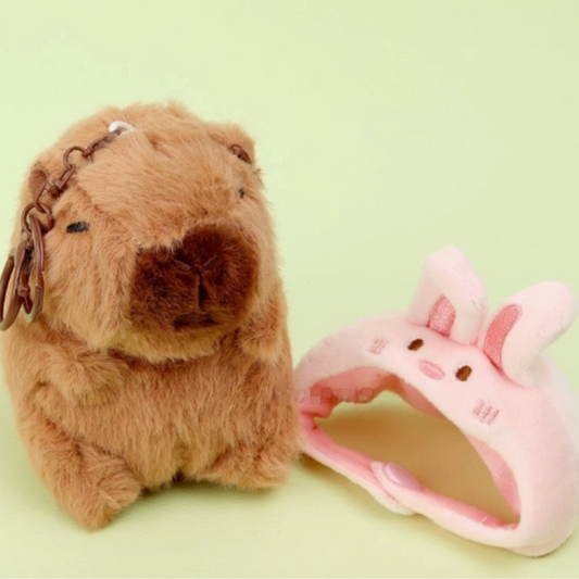 Plush keychain and phone case on a light green background