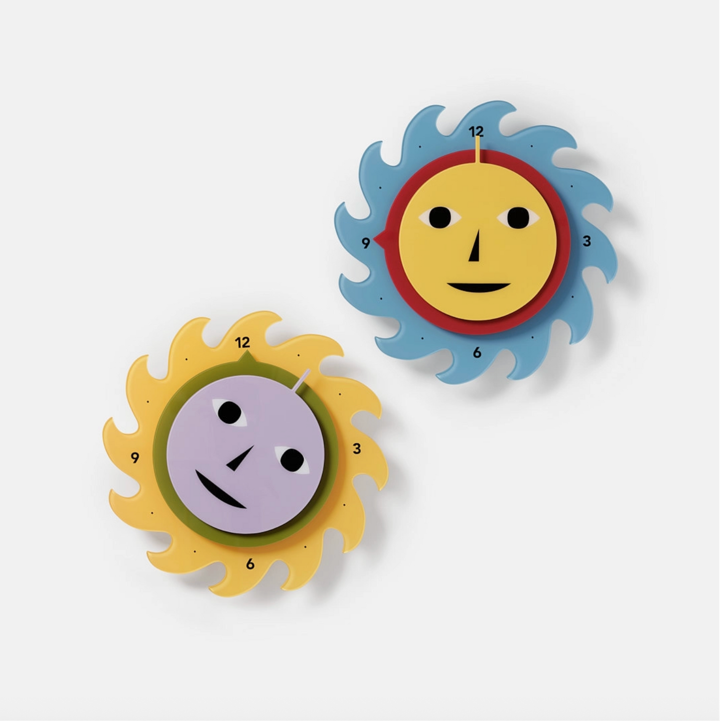 Two colorful wall clocks with sun designs on a white background