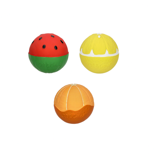 Three colorful fruit-shaped dog toys on a white background