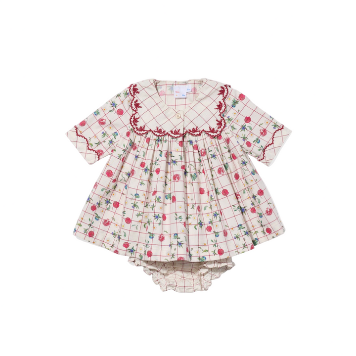 Children's dress with floral and checkered pattern on a white background