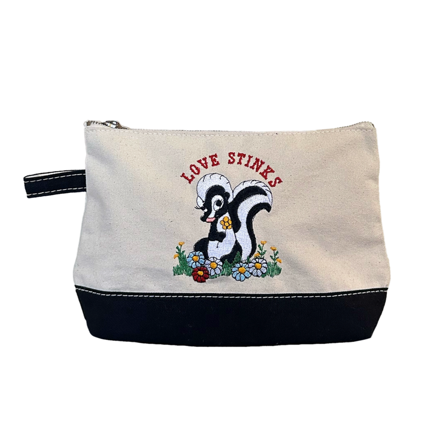 Canvas pouch with skunk illustration and 'Love Stinks' text on a white background - Little-ish