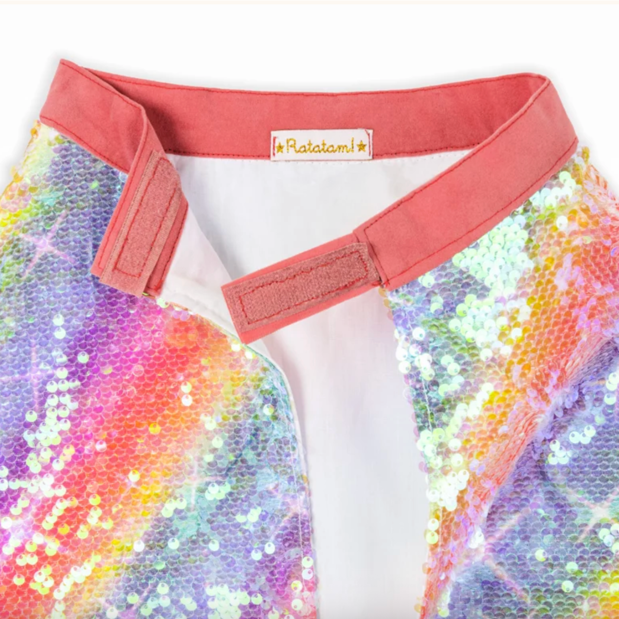 Multicolored sequin fabric with a coral belt and 'Ratatouille' label.