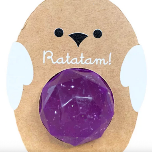 Purple gemstone in a bear-shaped cardboard holder with 'Ratatam!' text