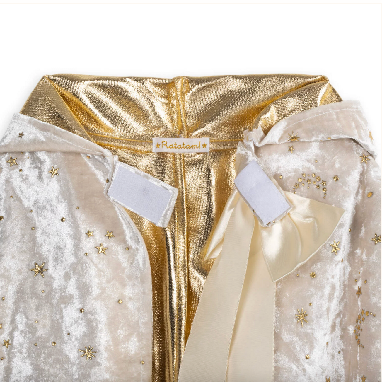 Gold and white garment with a bow and 'Frida' label on a white background