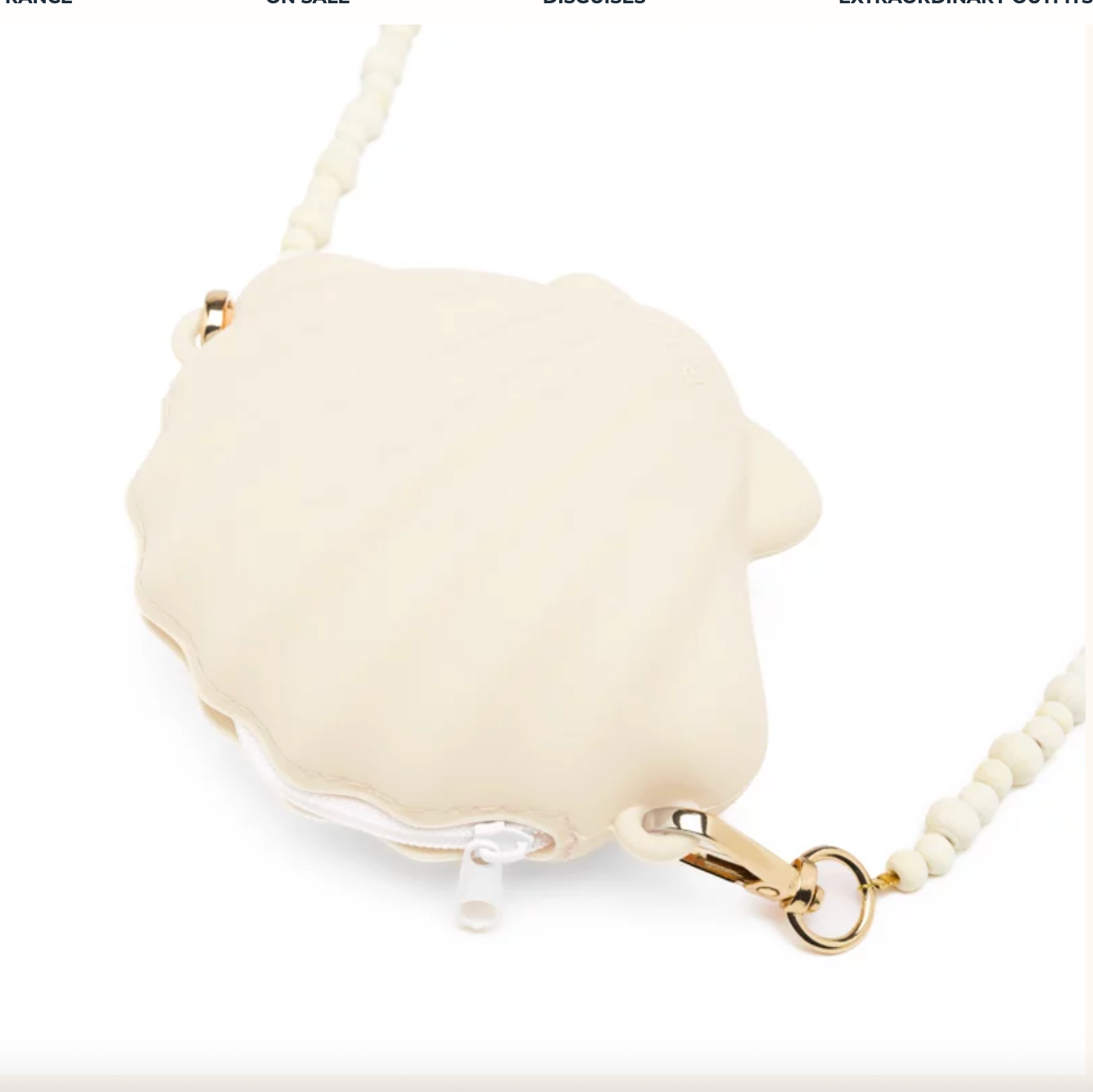 Cream-colored compact mirror with gold chain on a white background
