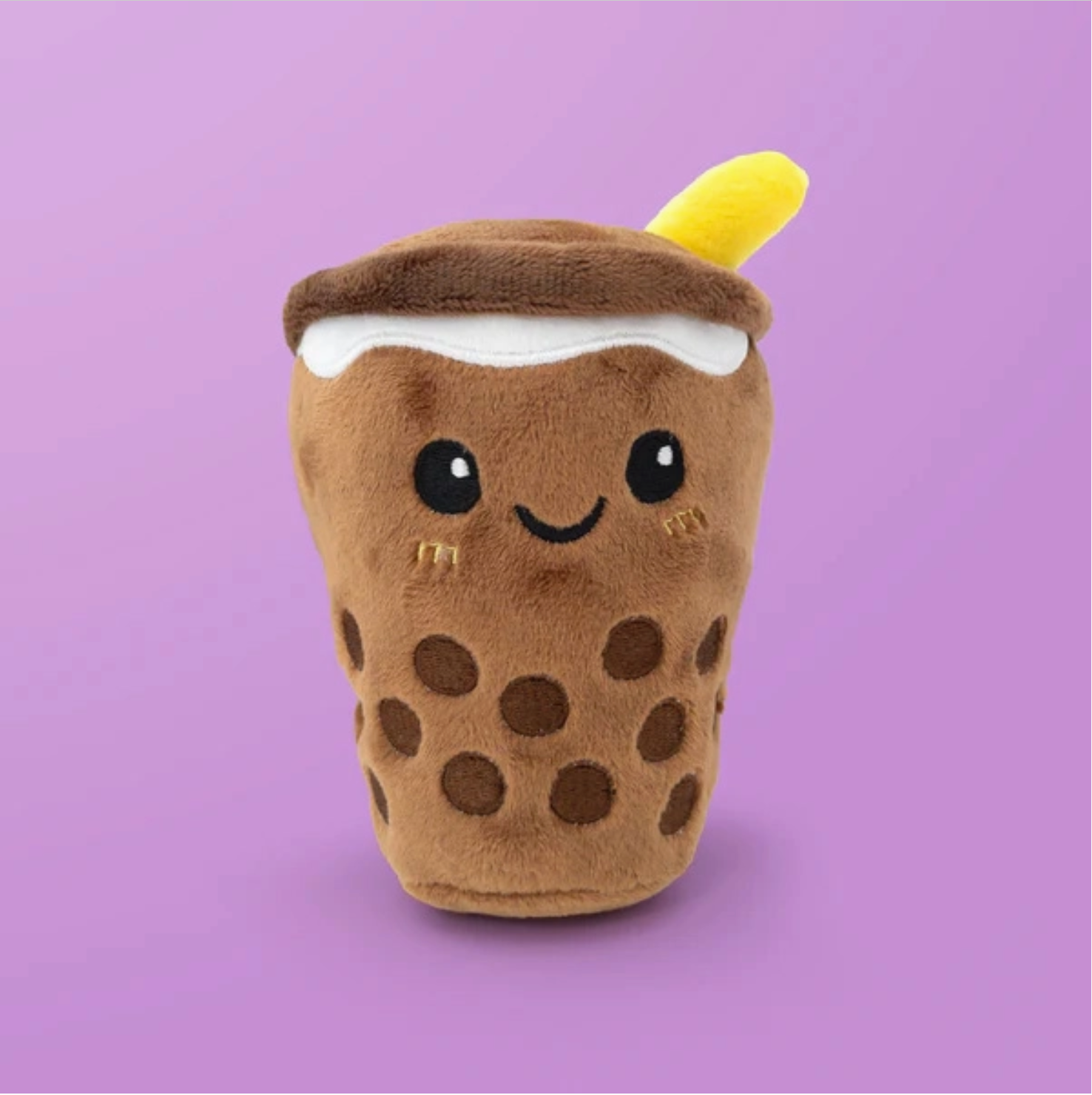 Plush toy resembling a brown polka dot drink with a yellow straw on a purple background - Little-ish
