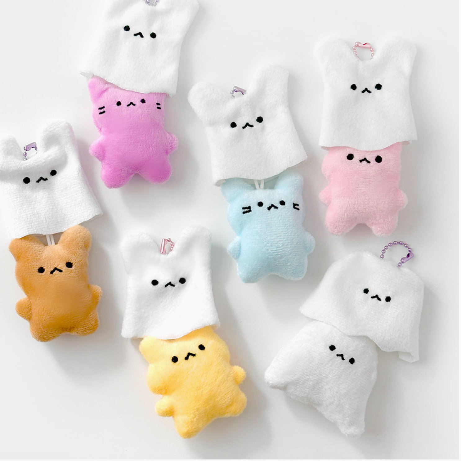 Set of cute plush toys with various colors on a white background