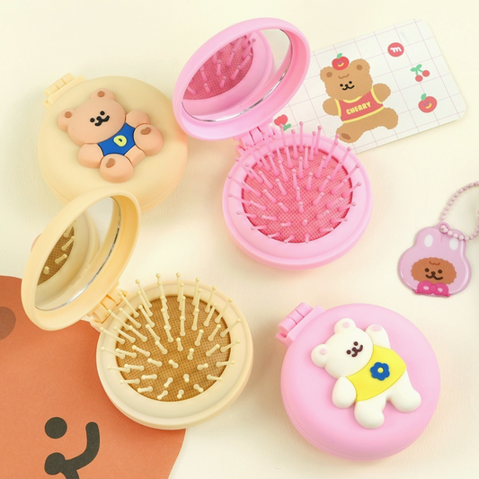 Compact mirror with bear design on a light background