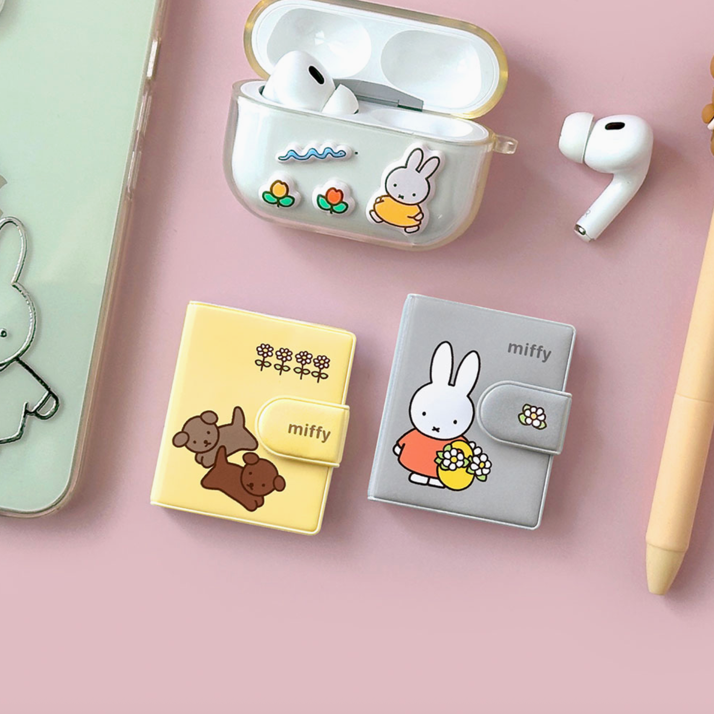 Cute cartoon character-themed product cases on a pink surface