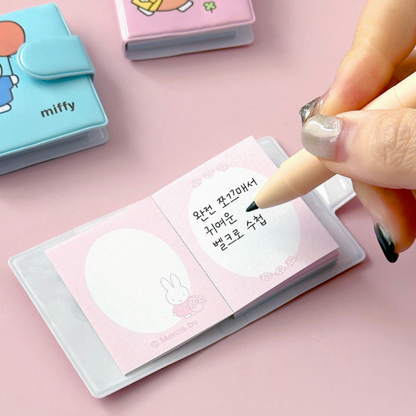 Notebook with cute design, pen, and 'miffy' branding on a pink background