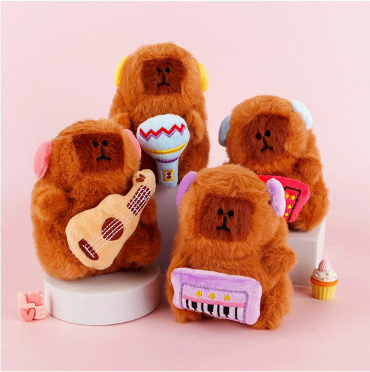 Four brown teddy bear toys with musical instruments on a pink background