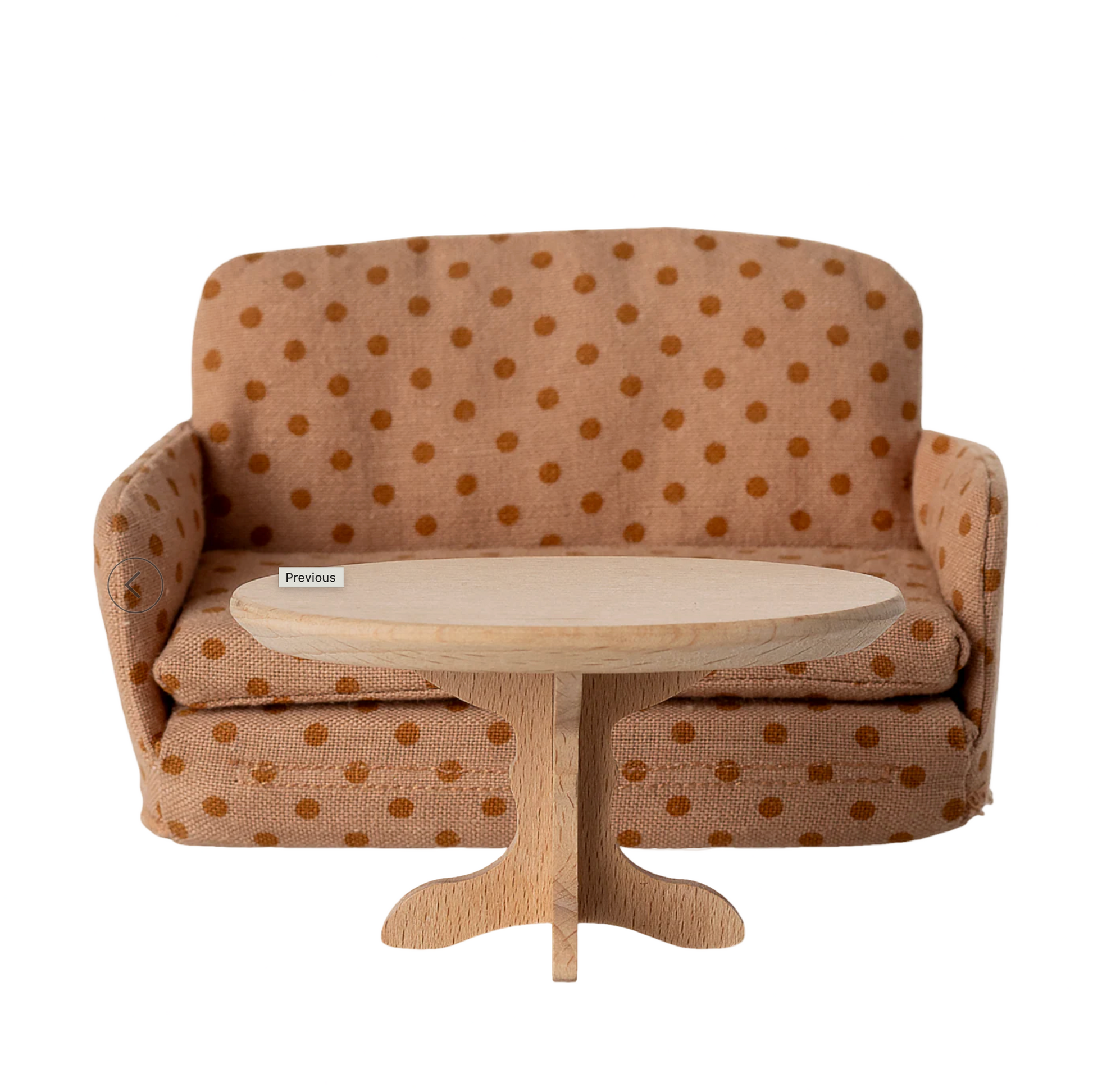 Brown polka dot sofa with a wooden coffee table on a computer screen.