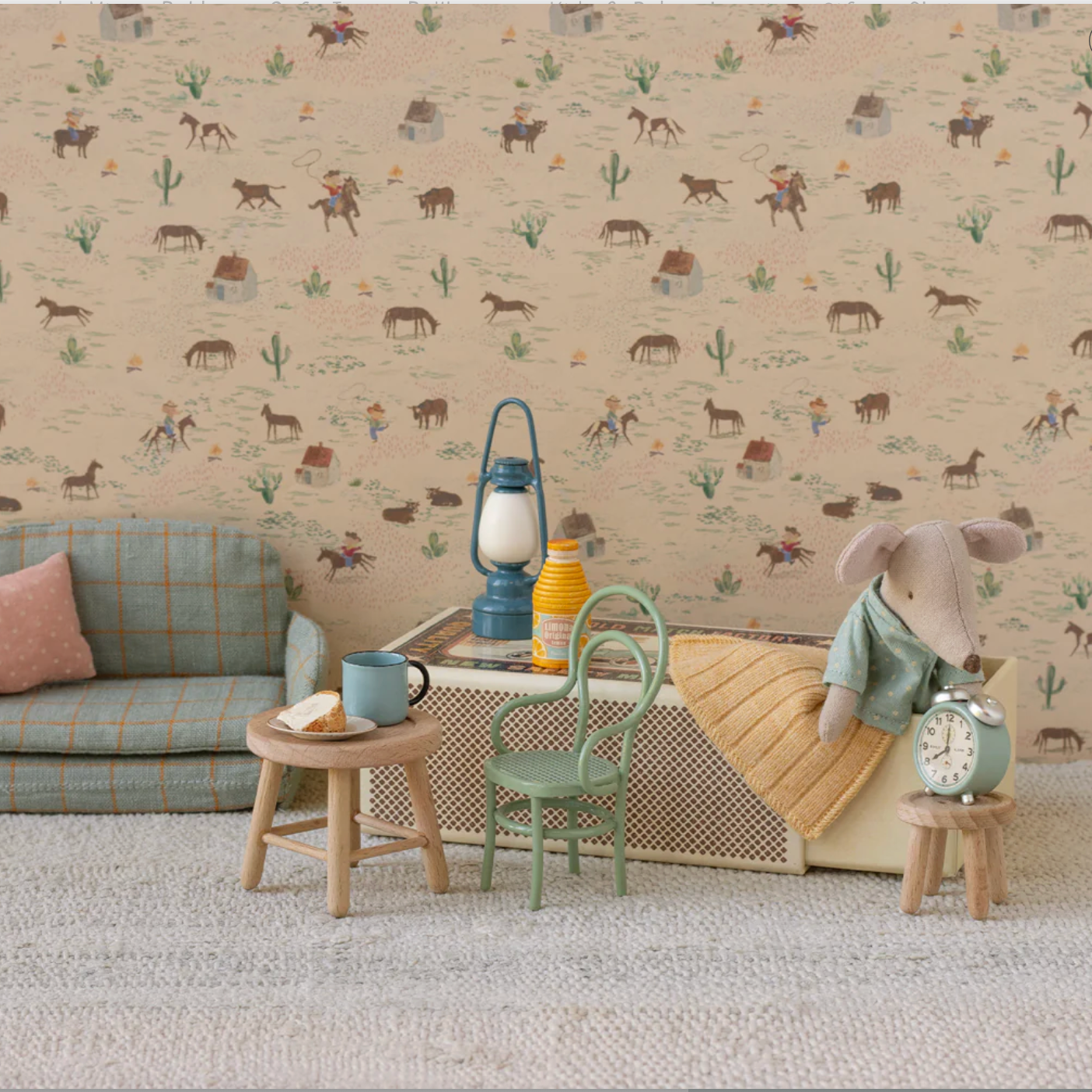 Children's room with patterned wallpaper, sofa, and toys. - Little-ish
