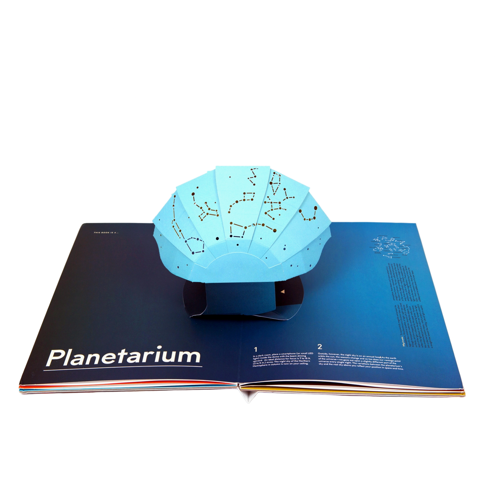 Planetarium product on an open book with a computer screen in the background