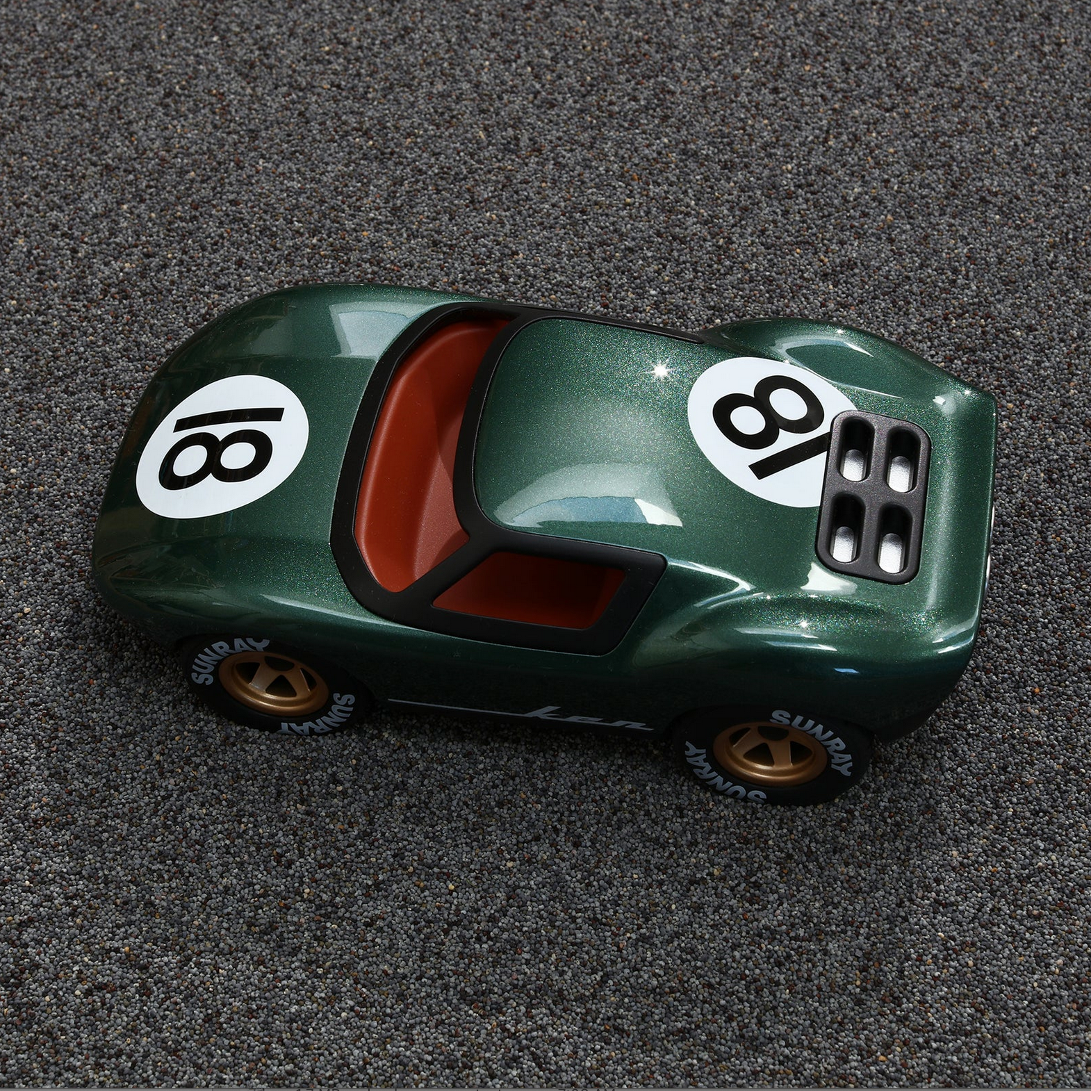 Toy car with number 18 on a gray surface