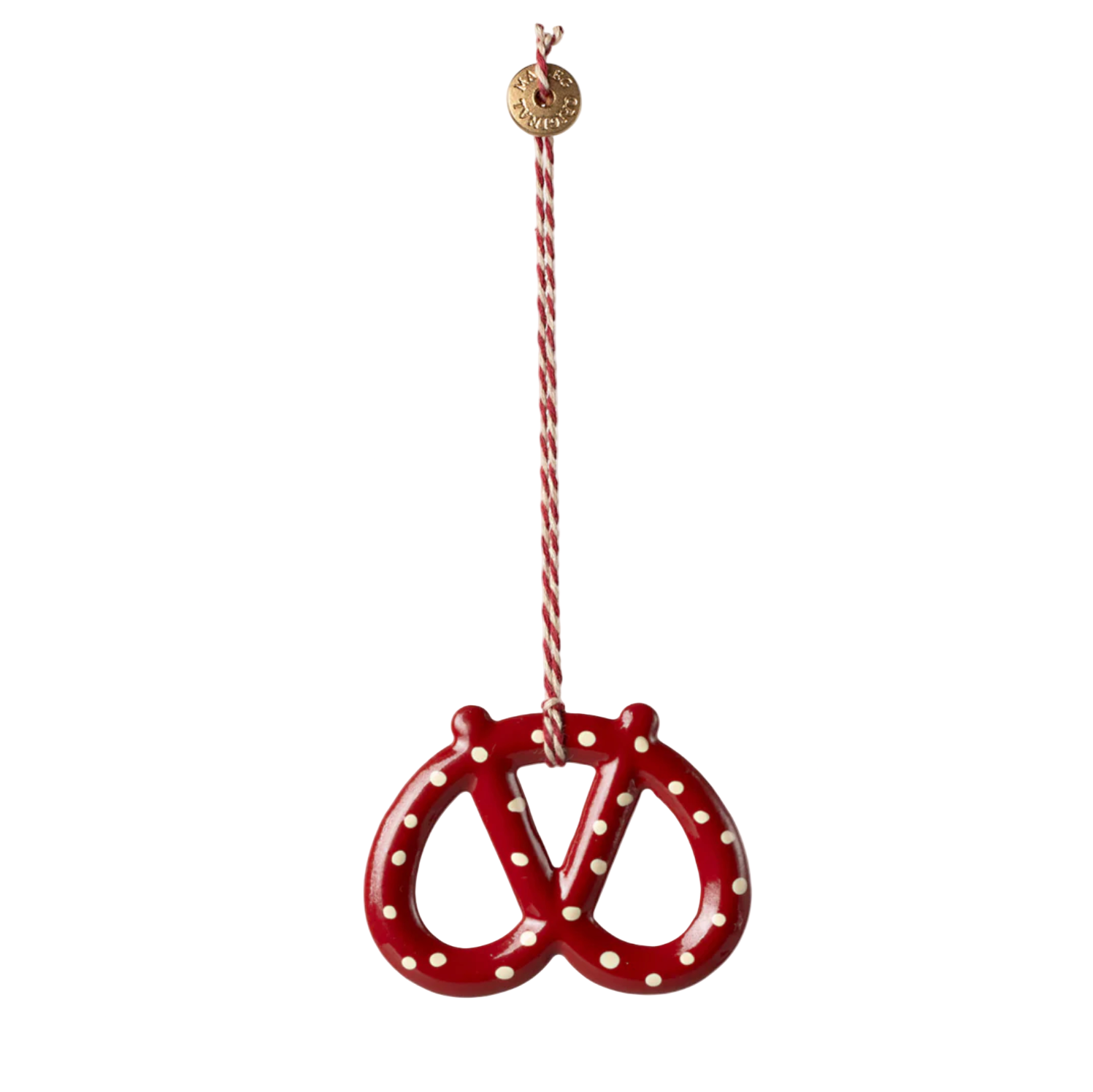 Red pretzel-shaped ornament with white polka dots on a white background - Little-ish