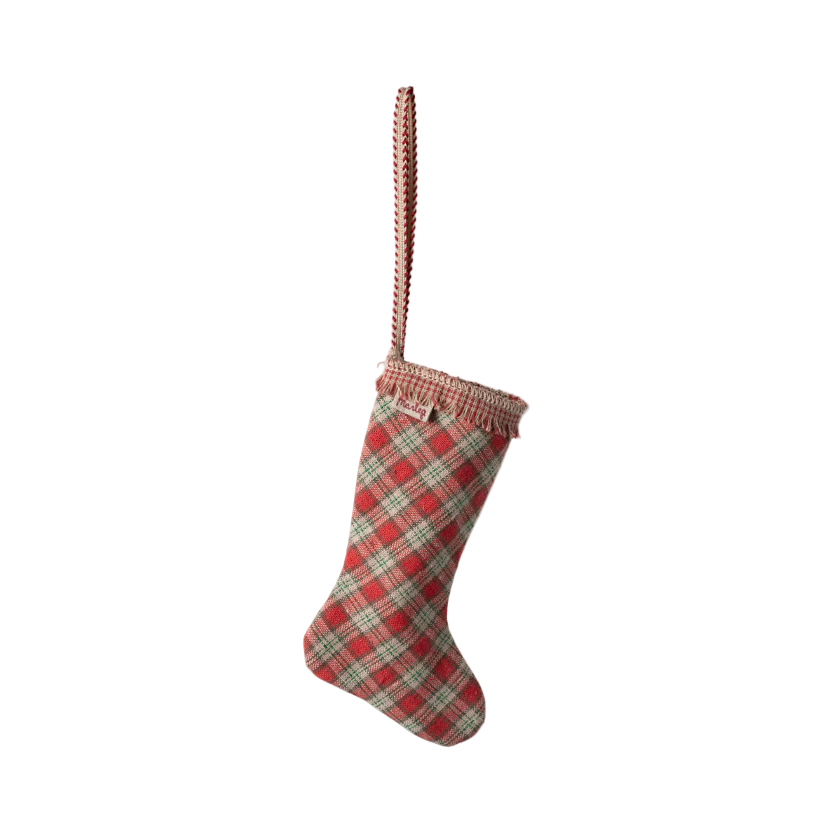 Red and green plaid Christmas stocking on a white background - Little-ish