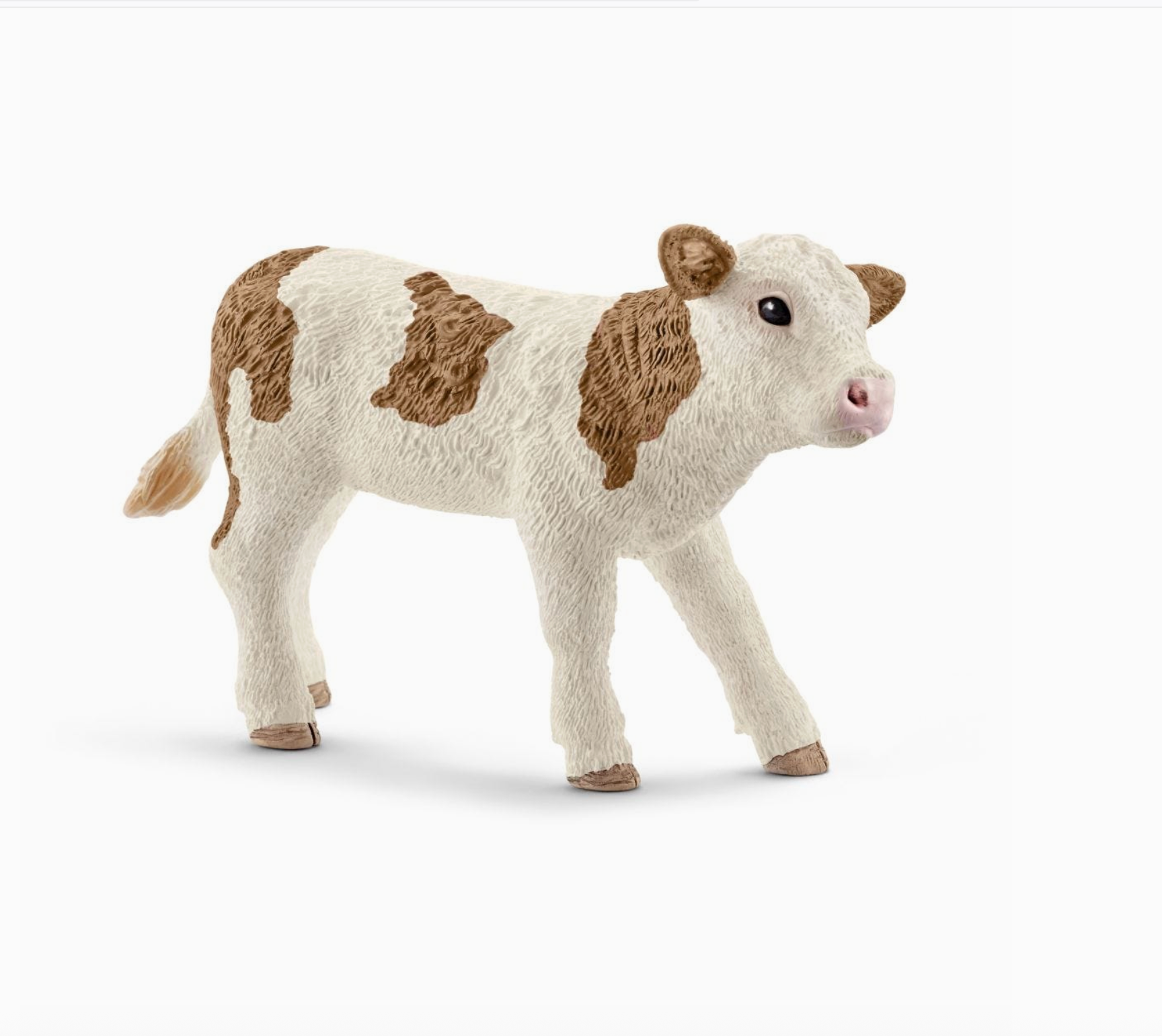 Plush toy cow with brown patches on a white background - Little-ish