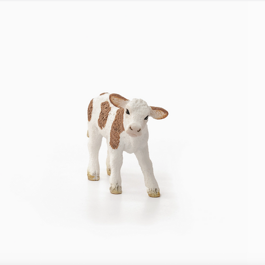Stuffed animal cow toy on a white background
